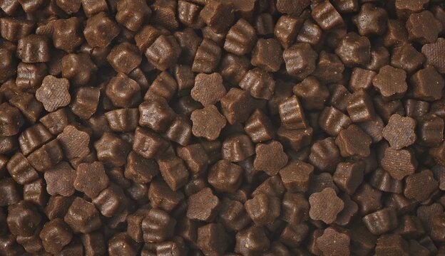 Dryed pet food in star shape. Panoramic background texture.	