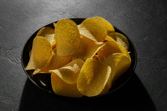 pringles chips on a black background