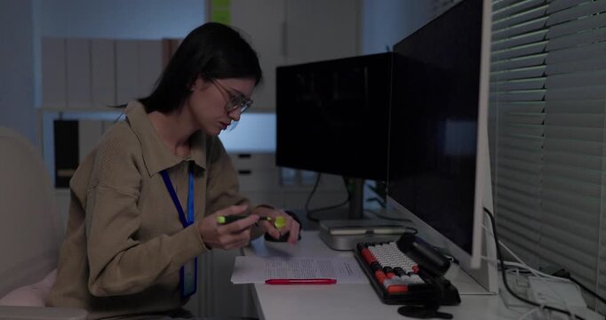 Woman machine learning researcher reviewing printed model results with highlighter at desk