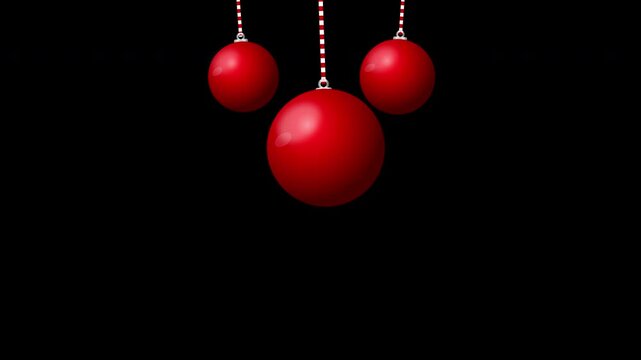 Three red Christmas ornaments hanging on strings against a dark background