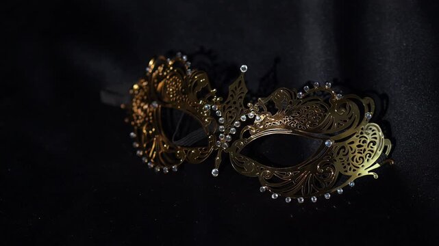 Golden Glitter Carnival Mask with Ornamental Pattern on Black Background.
Elegant golden carnival mask decorated with shimmering glitter and intricate ornamental patterns