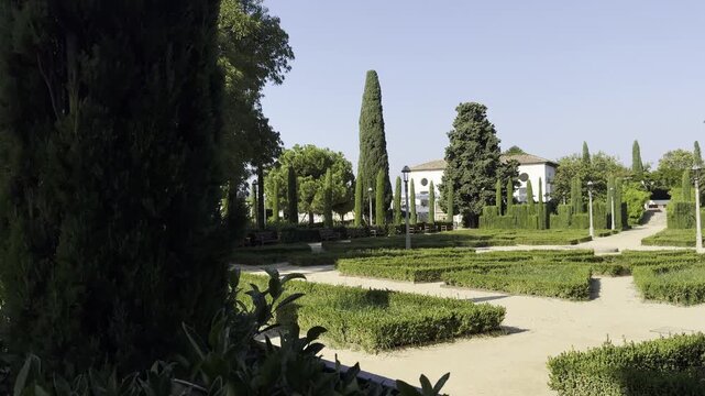 Barcelona, Spain, October 13, 2026 - The historic La Font del Gat building, now home to La Greca restaurant, partially hidden by greenery in the picturesque Laribal Gardens on Montjuic hill.