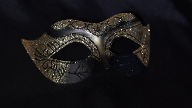 Golden Glitter Carnival Mask with Ornamental Pattern on Black Background.
Elegant golden carnival mask decorated with shimmering glitter and intricate ornamental patterns