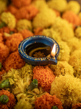 Traditional Clay Diya with a Lit Flame Against a Dreamy Warm Golden Bokeh Background, Festive Diwali Close-Up Shot