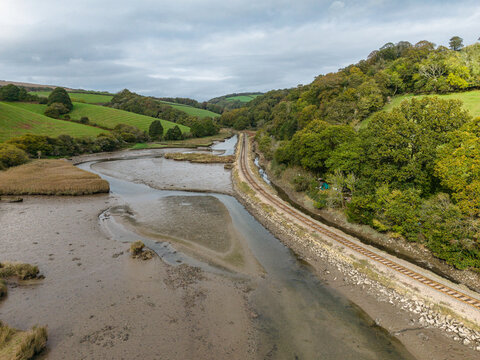 Aerial view of Looe estuary with railway line and adjacent road in Cornwall