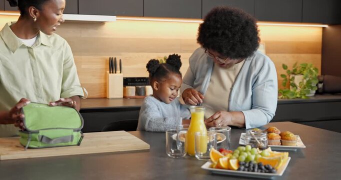 Grandma, mom and food preparation with child in kitchen for meal or kindergarten snack in home. Black family, grandmother or mother getting ready with muffin for back to school nutrition or vitamin C