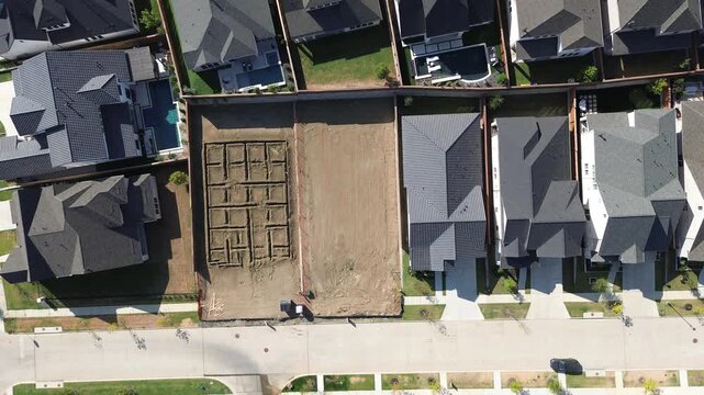 Bordering residential estates overlook leveled construction pads waiting for slab pouring along Frisco. Interconnecting asphalt avenues provide direct neighborhood access across growing, Texas
