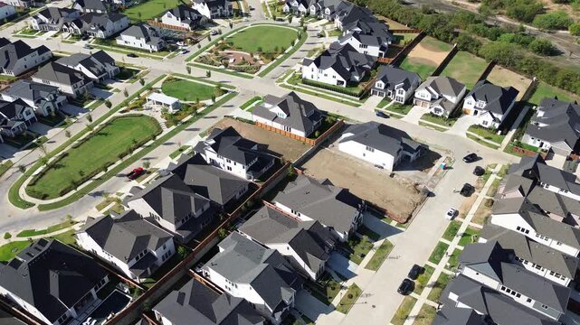 Sprawling suburban developments reveal active housing construction next to finished home rows along Frisco. Clean neighborhood streets interconnect expanding community parcels under, Texas