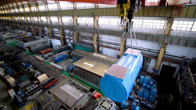 Industrial hoist installed overhead crane hanging moving pulley system ceiling inside large warehouse factory building, machine lifting equipment consist hoist, hook wire rope on beam girder structure