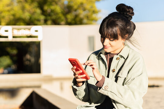 Young woman enjoying connectivity using smartphone outdoors
