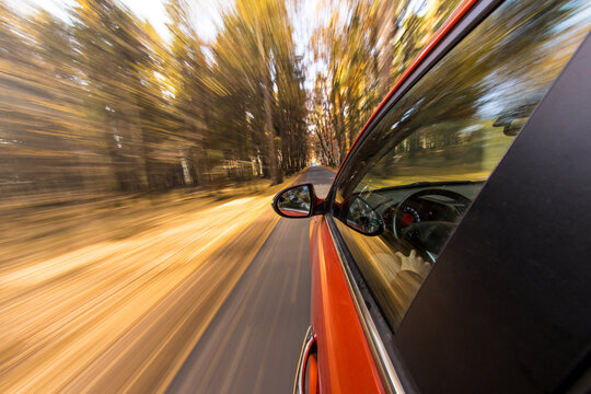 Fast Moving Car Driving Through Autumn Forest with Motion Blur