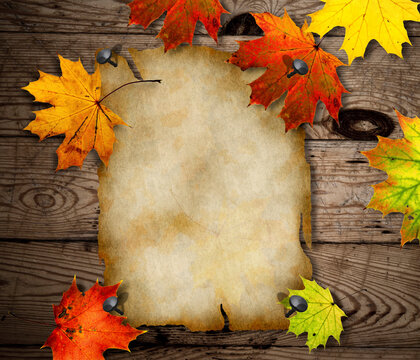 Colorful Autumn Leaves on Rustic Wooden Background with Copy Space