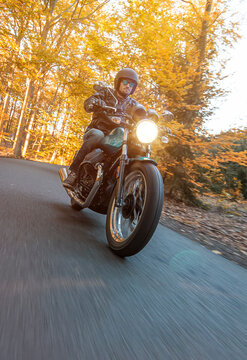 Motorcycle Riding Fast on an Autumn Road with Motion Blur