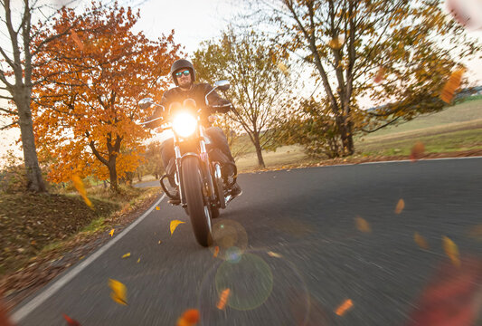 Motorcycle Riding Fast on an Autumn Road with Motion Blur