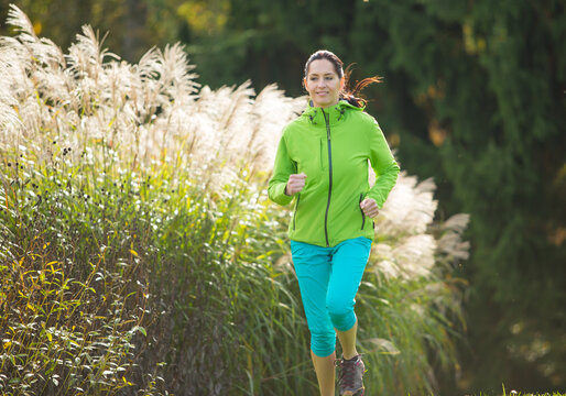 Woman Running in a Colorful Autumn Park