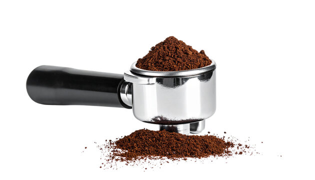 A stainless steel espresso portafilter with a black handle, filled with freshly tamped coffee grounds forming a smooth dark puck, isolated on transparent background