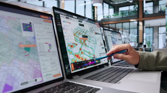 Market Analyst Studying Customer Demographics Using Software
