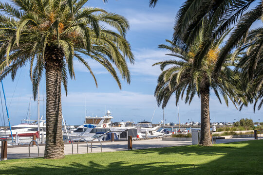 Yachts, motorboats, and sailboats moored along the marina boardwalk at Wyndham Harbour in Werribee South, Melbourne, Victoria, Australia. Waterfront boardwalk&nbsp;and bayside recreational precincts.