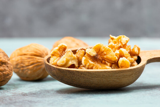 Walnuts in a wooden shovel, healthy nuts food, nutrition, ingredients for baking, protein and antioxidants