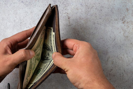 Opening Wallet Revealing Limited Cash