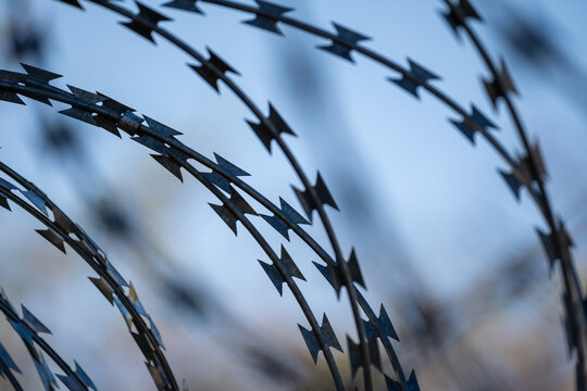 Sharp Razor Wire Against Blurred Blue Background
