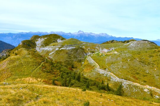 Meadows covered hills near Možic hill with Triglav mountain in Julian alps in Gorenjska, Slovenia