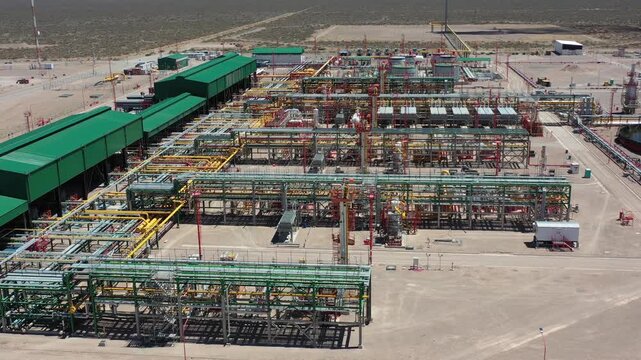 A drone captures an aerial view of the Fort&iacute;n de Piedra gas processing plant in the Vaca Muerta gas field, Neuqu&eacute;n, Argentina. A lit flare is visible.