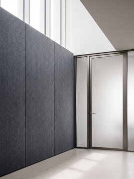Modern Office Interior With Dark Wall Panels And Glass Door