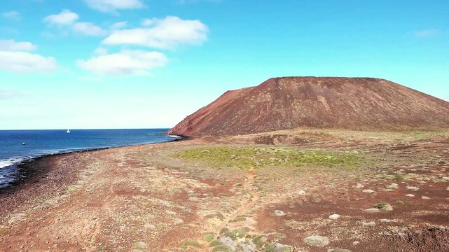 Aerial view of Montana de La Caldera on Isla de Lobos Island, Fuerteventura, Canary Islands, Spain, Europe. Flying towards the Montana de La Caldera volcano on Isla de Lobos near Fuerteventura, Canary