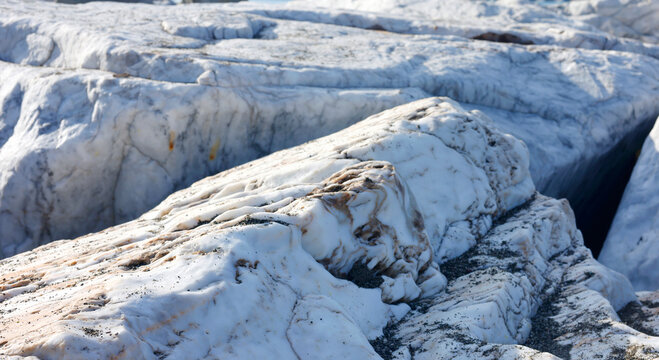 Natural white marble rock texture geological background raw stone surface. Fractured metamorphic mineral formation rough coastal outcrop patterns. Earth science mineralogy education research.