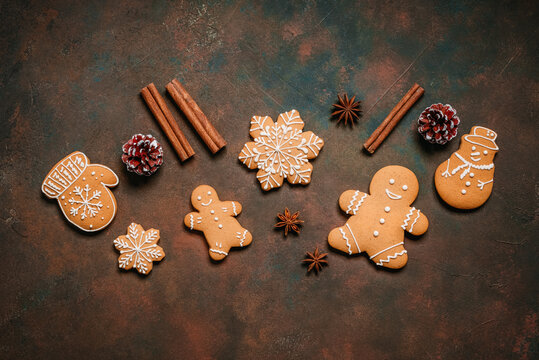 Close up of gingerbread cookies on dark grunge background, top view, flat lay