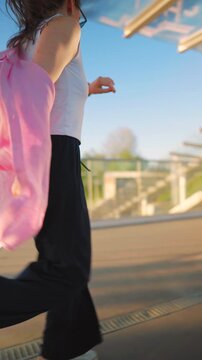 Caucasian woman pulling a suitcase and running, late for flight. 