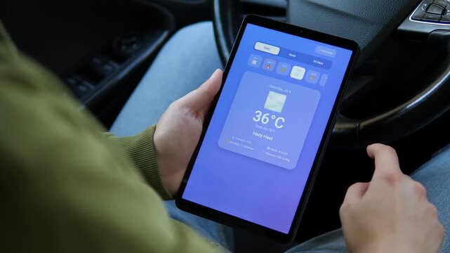 Person checks a tablet weather forecast showing extreme heat above 40&deg;C, highlighting heatwave risk, climate change, UV exposure and growing concern over dangerous summer temperatures.
