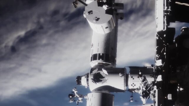 A space station is visible as it orbits earth. The image shows the dark space above and the blue and white colors of earth below. The space station has various modules and instruments on it.