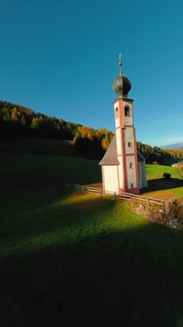 FPV Aerial view of the Church of St. Johann in Ranui at South Tyrol, Italy. 