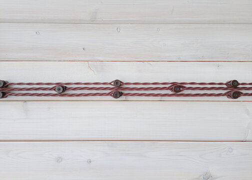 electrical wires on the wall of wooden house, closeup of photo