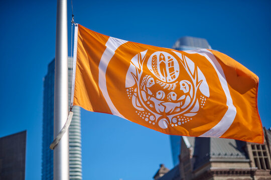 Toronto, Ontario, Canada&mdash;September 30th, 2025: A flag lowered at half-mast at Toronto City Hall&rsquo;s Nathan Phillips Square for all the Indigenous children that died at residential schools in Canada. Tod