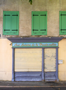 Colorful french houses on the central square of Quillan (Aude, France) with traditonal window shutters
