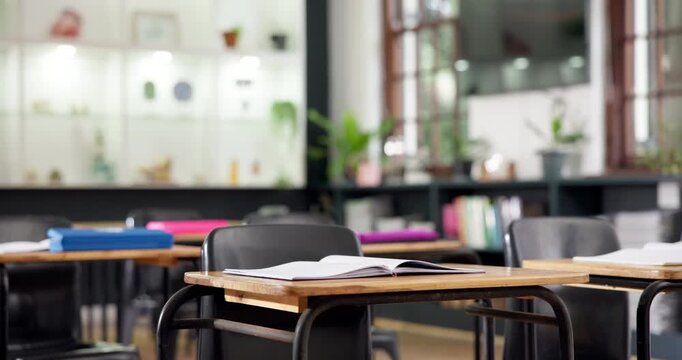 Education, notebook and desk in school for learning, study material or research in empty classroom. Stationery, campus or table in college for growth, development or scholarship opportunity in lesson