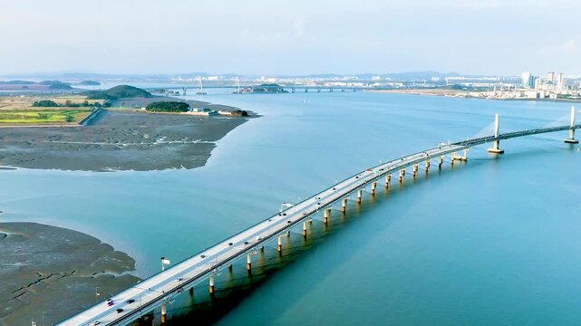 Cinematic drone view of a modern sea suspension bridge, Cheongnahaneul Bridge, with the sea landscape in Incheon.