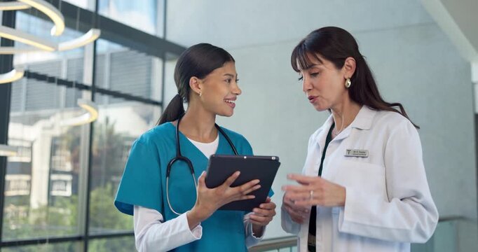 Talking, doctor and student in hospital with tablet, patient report or consulting for treatment plan. Healthcare, residency and woman with intern on tech for medical service, training and learning