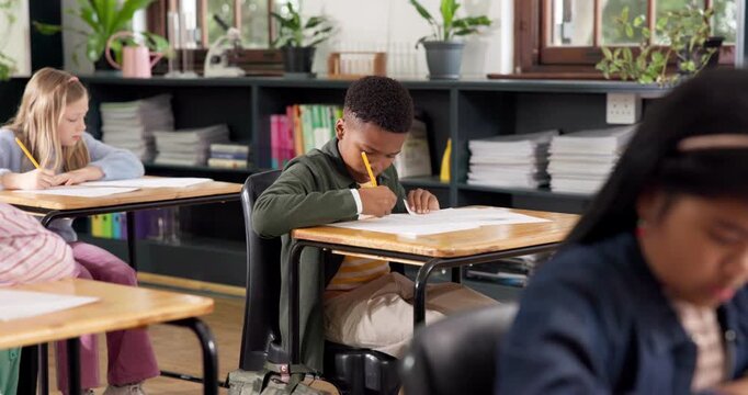 Education, kid and writing on test paper in classroom for academic assessment, knowledge or quiz. Exam, student learning and boy in middle school for development, study and multiple choice questions