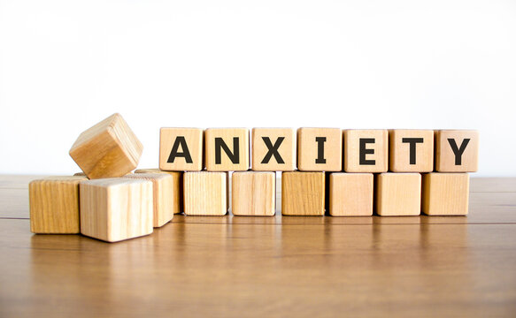 Anxiety word symbol. Concept word Anxiety on beautiful wooden blocks. Beautiful wooden table white background. Business medical anxiety word concept. Copy space.