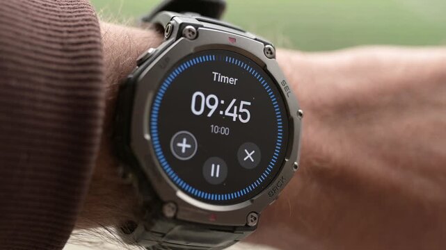 Close-up of smart watch on man wrist with active timer countdown display