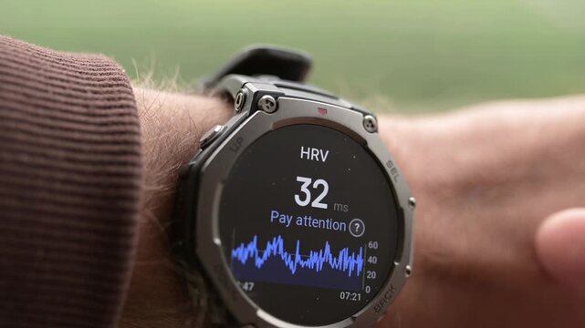 Man checking HRV heart rate variability on smartwatch close up