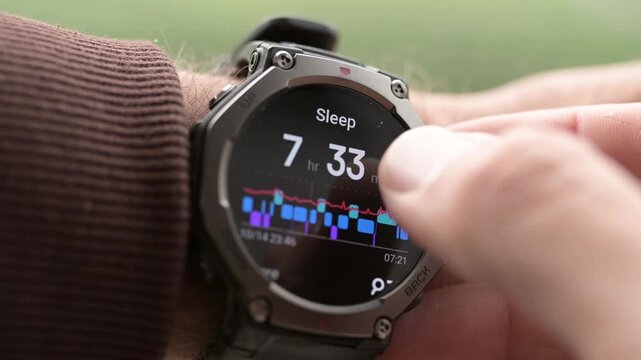 Close-up of smartwatch on wrist displaying sleep tracking data and sleep stages