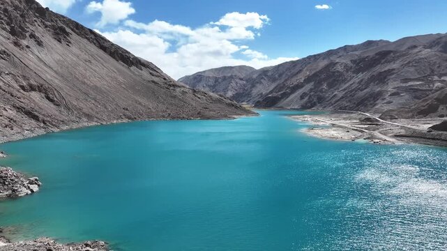 bandidier blue lake in xinjiang with turquoise water and barren mountains