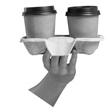 A hand holds a molded cardboard carrier with two takeaway cups and black lids, isolated against a transparent background.
