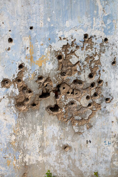 Bullet holes on a white plastered wall, Northern Province, Mannar, Sri Lanka