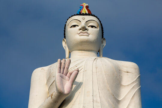 Face and raised hand of the giant Buddha statue near Sigiriya Rock Fortress, Central Province, Sigiriya, Sri Lanka